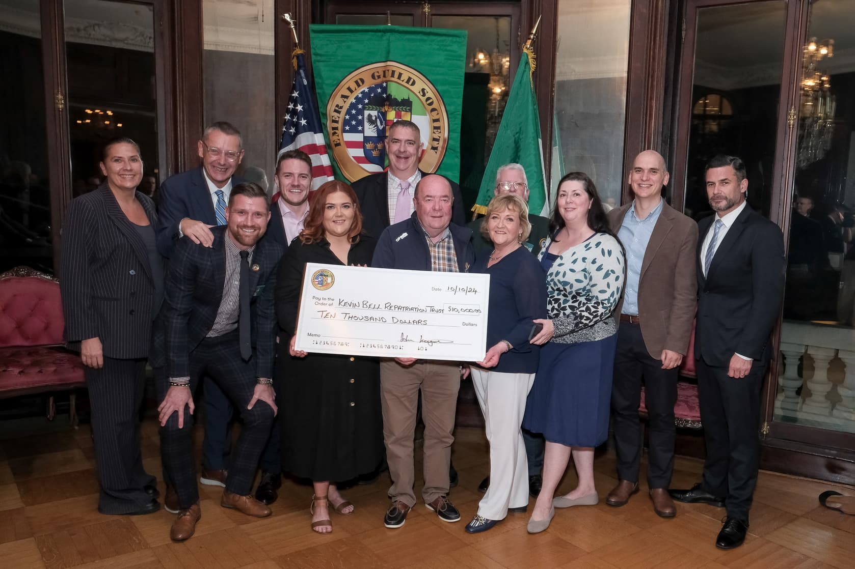 Members of the Emerald Guild Society presenting a charitable donation at a Guild event.